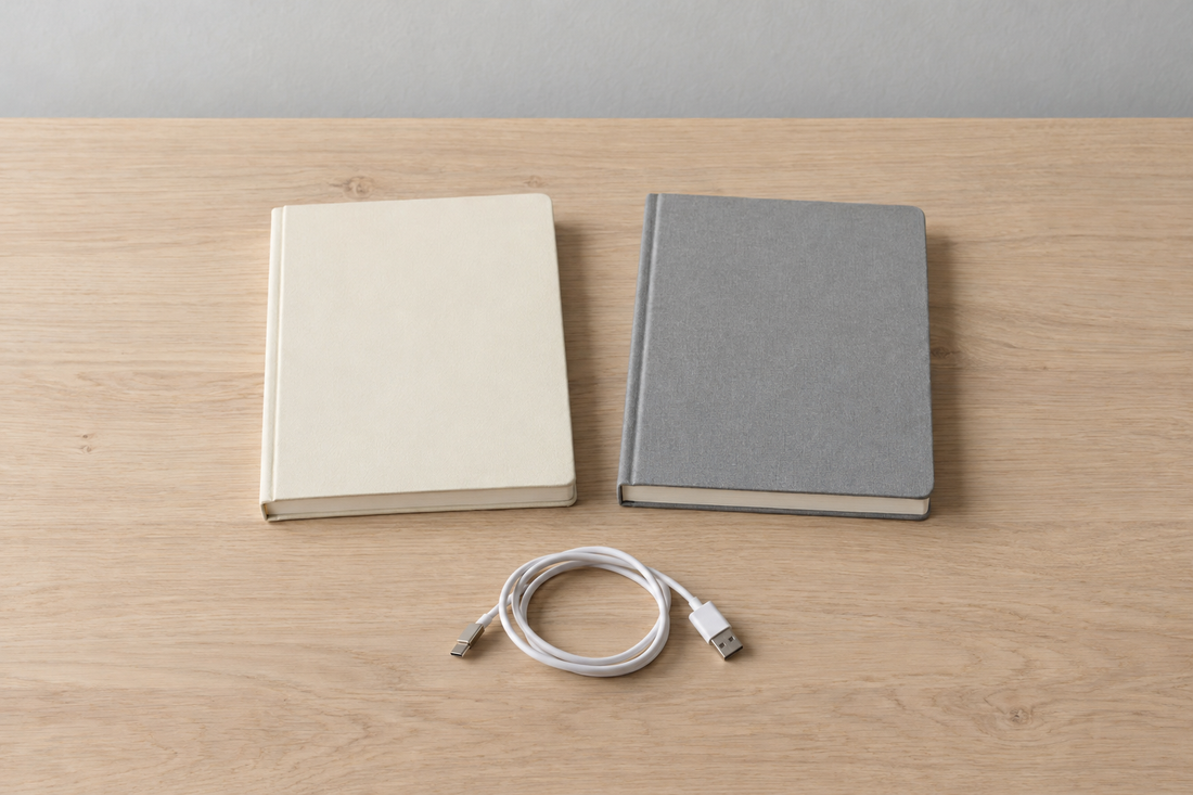 Illustrative blank notebooks and an unbranded USB cable on a desk; no Breo or Beminda product is shown.