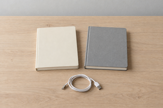 Illustrative blank notebooks and an unbranded USB cable on a desk; no Breo or Beminda product is shown.